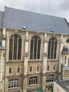 a large brick building with a black roof at Le Mans Cosy in Le Mans