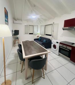eine Küche und ein Wohnzimmer mit Tisch und Stühlen in der Unterkunft Paradis des sables B in La Désirade