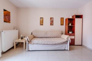 a living room with a couch and a table at Bella Vista - Historic Centre -4th floor in Corfu