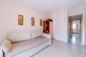a white couch sitting in a living room at Bella Vista - Historic Centre -4th floor in Corfu