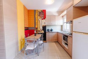 a kitchen with a table and chairs and a painting on the wall at Bella Vista - Historic Centre -4th floor in Corfu