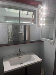 a bathroom with a sink and a mirror at Beachfront Hotel Cha Am in Cha Am +31 photos