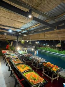a buffet line with a pool of food on tables at Homestay in Nhơn Trạch