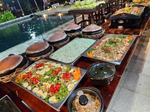 a buffet of different types of food on a table at Homestay in Nhơn Trạch +19 photos