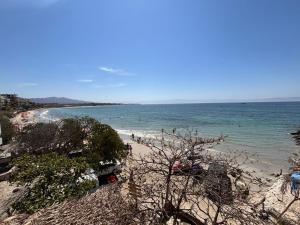 a beach with a bunch of people in the water at Amaizing view Islas Marietas in Punta Mita
