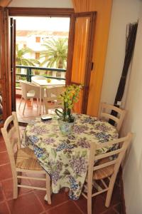 a dining room table with a vase with a plant on it at Residence La Bricola 239 in I Casoni