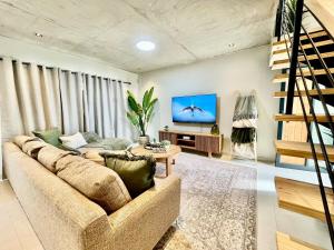 a living room with a couch and a tv at Rustic Hills #30 in Swakopmund