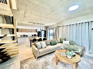 a living room with a couch and a table at Rustic Hills #30 in Swakopmund +15 photos