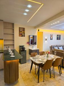a kitchen and living room with a table and chairs at Monte Opulent Haven in Eldoret