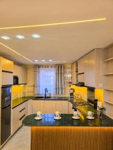 a kitchen with wooden cabinets and a black counter top at Monte Opulent Haven in Eldoret