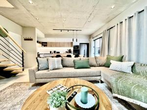 a living room with a couch and a table at Rustic Hills #30 in Swakopmund