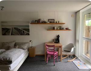 a bedroom with a bed and a table and chairs at Souterrain Appartment, eigene Dusche u WC in Detmold
