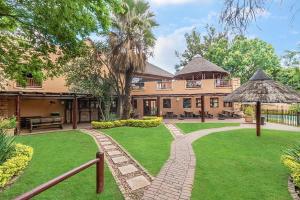 an exterior view of a house with a lawn at The palace in Sandton