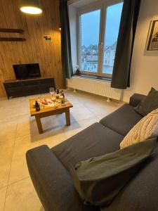 a living room with a couch and a table at Bivouac 101 in Bastogne