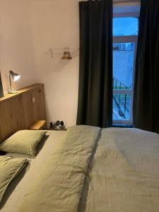 a bedroom with a large bed with a window at Bivouac 101 in Bastogne