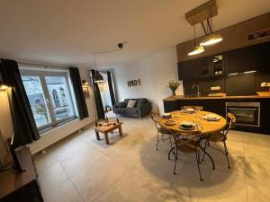 a kitchen and living room with a table and chairs at Bivouac 101 in Bastogne