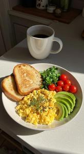 a plate of scrambled eggs and toast with vegetables and a cup of coffee at Meegoda Villa in Kalutara