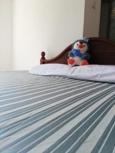 two stuffed animals sitting on top of a bed at Meegoda Villa in Kalutara