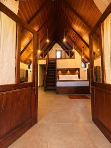 a large room with a bed and a staircase at Coffee Cabanas in Matale