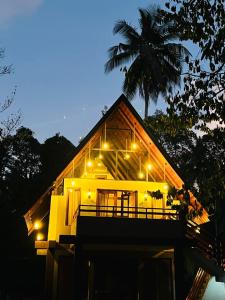 a house with lights on top of it at night at Coffee Cabanas in Matale +11 photos
