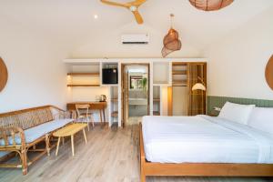 a bedroom with a bed and a dining room at Orion Healing Centre in Srithanu