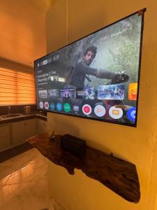 a flat screen tv hanging on a wall at Ohana Trining in General Luna