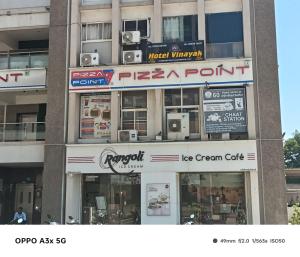 a store front of a building with signs on it at Hotel Vinayak Naroda in Ahmedabad