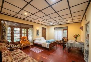a living room with a teddy bear sitting on a bed at Tree Avenue Villa Dambulla in Galewela