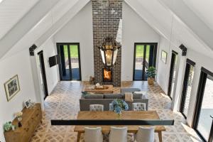 an open living room with a brick wall at The Mist, Luxury Farm w Fireplace & Hot tub in Exeter