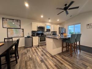 a large kitchen with a table and a ceiling fan at Relaxing 3BR 2 En Suites, Bikes & Helmets in Sheridan