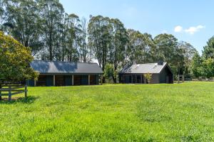 a barn and a house in a field at The Mist, Luxury Farm w Fireplace & Hot tub in Exeter +30 photos