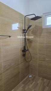 a shower with a shower head in a bathroom at Mellow Breeze - Nuwara Eliya in Nuwara Eliya