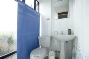 a bathroom with a white toilet and a sink at Amplia casa en Reñaca para 10 personas in Viña del Mar +21 photos