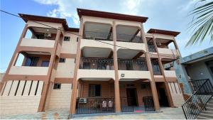 a tall building with balconies on the side of it at Ragant Hotel in Kwapro