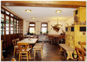 a dining room with wooden tables and chairs at Pension Teichschänke in Zwönitz
