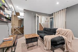 a living room with a couch and a table at 5BR Wild Rose- Meadows, AC, Garage, Sleeps 12 in Edmonton
