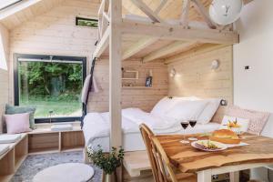a tiny house with a bed and a table at Posestvo Brida in Ilirska Bistrica +41 photos