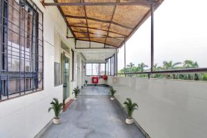 an empty hallway with plants in a building at Hotel O Sunshine Inn in Nagpur