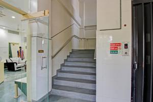 a hallway with a staircase in a building at Hotel O Sunshine Inn in Nagpur