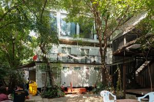 a building with a balcony on the side of it at The Yard Bangkok Hostel in Bangkok
