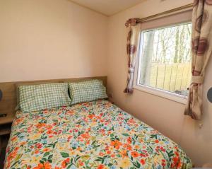 a bed in a small room with a window at Sunflower Retreat in Cresswell