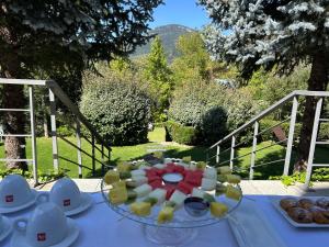 a table with a plate of food on top of it at Hotel Luces del Poniente in Cercedilla