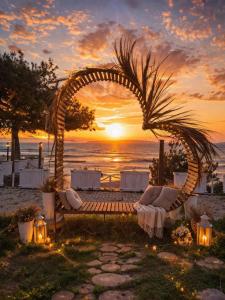 an arch at a wedding on the beach at sunset at ROSe OTEL in Ezine