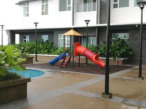 a playground in front of a building with a slide at NF Suites D'Perdana Condo in Kota Bharu