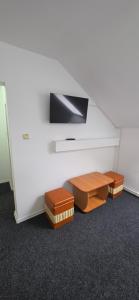 a white wall with a flat screen tv on a wall at Pensiune Urban in Borsec