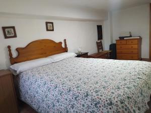 a bedroom with a large bed and a dresser at La caseta del llorer in Catadau
