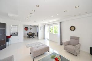 a living room with two chairs and a table at Zotina Residence in Tivat