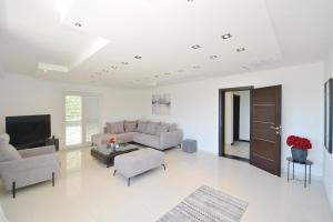 a living room with a couch and a tv at Zotina Residence in Tivat +28 photos
