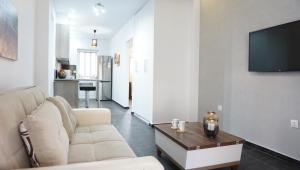 a living room with a couch and a table at Athenean Sea Breeze in Vari