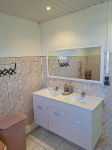a bathroom with two sinks and a mirror at Villa Dijoux D'O in Entre-Deux +49 photos
